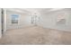 Spacious main bedroom with neutral carpeting, tray ceiling, and bright windows at 517 Hyde Ridge Trl, Loganville, GA 30052