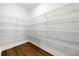 Well-organized pantry with wooden floor and white wire shelving at 517 Hyde Ridge Trl, Loganville, GA 30052