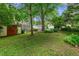 Backyard with shed and foliage with neighboring houses in the background at 2655 Appian Way, Decatur, GA 30030