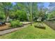 Backyard with gardening beds and lush green grass, and some playground equipment at 2655 Appian Way, Decatur, GA 30030