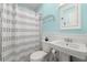 Bright bathroom features a white vanity, toilet, and shower with a patterned shower curtain at 2655 Appian Way, Decatur, GA 30030