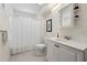 Clean bathroom with a white vanity, toilet, and shower featuring a white shower curtain at 2655 Appian Way, Decatur, GA 30030