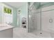Tiled bathroom with a glass shower, built in shelving, and windows at 2655 Appian Way, Decatur, GA 30030