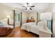 Bright bedroom features hardwood floors, a ceiling fan, and natural light from the windows at 2655 Appian Way, Decatur, GA 30030