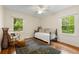 Sunlit bedroom with hardwood floors, a daybed, and a view of the lush outdoor greenery at 2655 Appian Way, Decatur, GA 30030