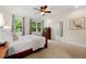 Comfortable bedroom with a ceiling fan, natural lighting, and an adjacent bathroom at 2655 Appian Way, Decatur, GA 30030