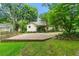View of house with covered porch and gravel driveway, surrounded by green grass at 2655 Appian Way, Decatur, GA 30030