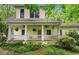 Charming home featuring a welcoming front porch with ceiling fans and meticulously landscaped surroundings at 2655 Appian Way, Decatur, GA 30030