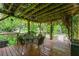 Back porch with a table and chairs covered in vines and plants at 2655 Appian Way, Decatur, GA 30030