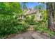 A charming home with a view of the side exterior, lush landscaping, and a quaint walkway at 2655 Appian Way, Decatur, GA 30030