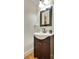 Charming powder room featuring a dark wood vanity and stylish fixtures at 2715 Woods Ridge Dr, Alpharetta, GA 30022