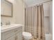 Cozy bathroom featuring a shower-tub combination with a decorative curtain and a modern vanity at 2715 Woods Ridge Dr, Alpharetta, GA 30022