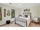 Comfortable bedroom with a metal bed frame, neutral decor, and natural light from the windows at 2715 Woods Ridge Dr, Alpharetta, GA 30022