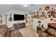 Bonus room featuring leather seating, decorations, TV, and storage at 2715 Woods Ridge Dr, Alpharetta, GA 30022