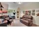 Cozy bonus room featuring leather seating, desk, and unique wall decor at 2715 Woods Ridge Dr, Alpharetta, GA 30022
