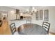 Dining area with wood table and view of the stainless steel appliances, living room, and decorations at 2715 Woods Ridge Dr, Alpharetta, GA 30022