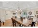 Dining room featuring hardwood floors, decorative light fixture and a large dining table at 2715 Woods Ridge Dr, Alpharetta, GA 30022