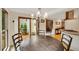 Dining area with wooden table and sliding glass door which leads to an outdoor patio at 2715 Woods Ridge Dr, Alpharetta, GA 30022