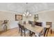 Formal dining room with hardwood floors, decorative lighting, and wainscoting detail at 2715 Woods Ridge Dr, Alpharetta, GA 30022