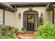 Elegant front entrance with a decorative glass door, stylish sconces, and lush landscaping around a brick entry at 2715 Woods Ridge Dr, Alpharetta, GA 30022