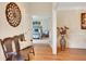 Hallway featuring hardwood floors, a wooden bench, and a glimpse into a cozy bedroom at 2715 Woods Ridge Dr, Alpharetta, GA 30022