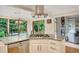 Modern kitchen island with gas cooktop, dishwasher, and a view of the living area and backyard at 2715 Woods Ridge Dr, Alpharetta, GA 30022