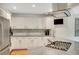 Bright kitchen with stainless appliances, white cabinets, granite countertops and a gas cooktop at 2715 Woods Ridge Dr, Alpharetta, GA 30022