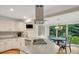 Bright kitchen featuring stainless appliances, white cabinets, and adjacent dining area at 2715 Woods Ridge Dr, Alpharetta, GA 30022