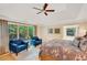 Bright primary bedroom boasting large windows, hardwood floors, and comfortable seating area at 2715 Woods Ridge Dr, Alpharetta, GA 30022