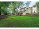 Lush green backyard with mature trees and a deck at 3267 Rememberance Trce, Lawrenceville, GA 30044