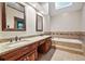 Bathroom features dual sinks, a large soaking tub, and tile accents at 3267 Rememberance Trce, Lawrenceville, GA 30044