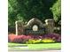 Connemara neighborhood entrance sign with lovely landscaped flower bed and healthy green grass at 3267 Rememberance Trce, Lawrenceville, GA 30044