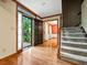 Inviting entryway with hardwood floors, stairs, and an open door view to lush greenery at 3267 Rememberance Trce, Lawrenceville, GA 30044