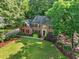 Aerial view of a two-story brick home with a landscaped front yard at 3267 Rememberance Trce, Lawrenceville, GA 30044