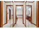 Hallway featuring mirrored closet doors and views into the bathroom with soaking tub at 3267 Rememberance Trce, Lawrenceville, GA 30044