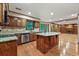 Open kitchen with granite countertops, an island and hardwood floors at 3267 Rememberance Trce, Lawrenceville, GA 30044