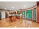 Eat-in kitchen with wood cabinets, hardwood floors, an island and lots of natural light at 3267 Rememberance Trce, Lawrenceville, GA 30044