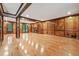 Open-concept living room with wood paneled walls, fireplace and gleaming hardwood floors at 3267 Rememberance Trce, Lawrenceville, GA 30044
