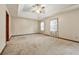 Large main bedroom with tray ceiling, ceiling fan, and ample natural light from two windows at 3267 Rememberance Trce, Lawrenceville, GA 30044
