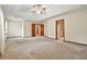 Spacious main bedroom featuring a tray ceiling and multiple doors leading to other rooms at 3267 Rememberance Trce, Lawrenceville, GA 30044