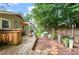 Backyard deck featuring a small bar, wooden steps, and landscape at 4040 Summit Dr, Marietta, GA 30068