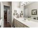Bathroom featuring a white vanity, long mirror, and decorative wall art at 4040 Summit Dr, Marietta, GA 30068