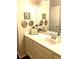 Elegant bathroom featuring decorative accents, a large mirror, and a pristine white vanity at 4040 Summit Dr, Marietta, GA 30068