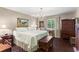 Cozy bedroom featuring a comfortable bed, elegant chandelier, and hardwood floors at 4040 Summit Dr, Marietta, GA 30068