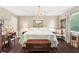 Cozy bedroom featuring a comfortable bed, elegant chandelier, and hardwood floors at 4040 Summit Dr, Marietta, GA 30068