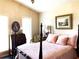 This comfortable bedroom features a four-poster bed, soft lighting, and beautiful decor at 4040 Summit Dr, Marietta, GA 30068