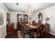 Elegant dining room with a grand chandelier, classic furnishings, and dark wood floors at 4040 Summit Dr, Marietta, GA 30068