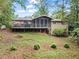 Backyard of the property with a spacious deck and screened-in porch at 4040 Summit Dr, Marietta, GA 30068