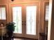 View of the double front doors boasting decorative glass panes with a potted plant at 4040 Summit Dr, Marietta, GA 30068