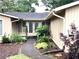 Charming home featuring a well-maintained front yard and a welcoming entrance with double doors at 4040 Summit Dr, Marietta, GA 30068